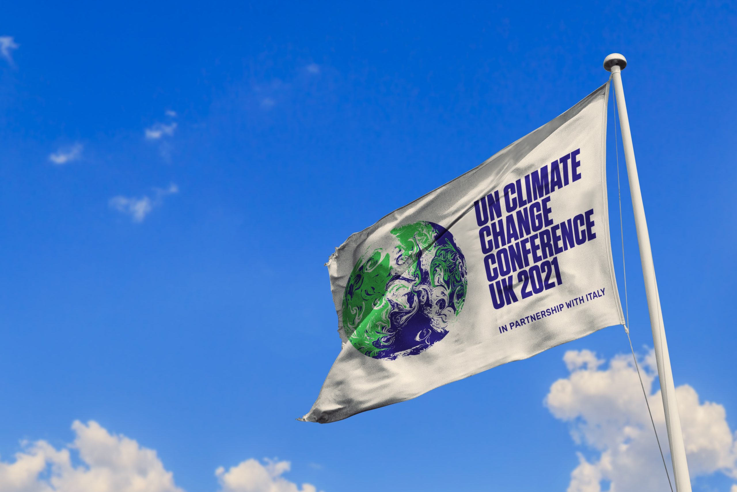 COP 26 flag with blue sky background